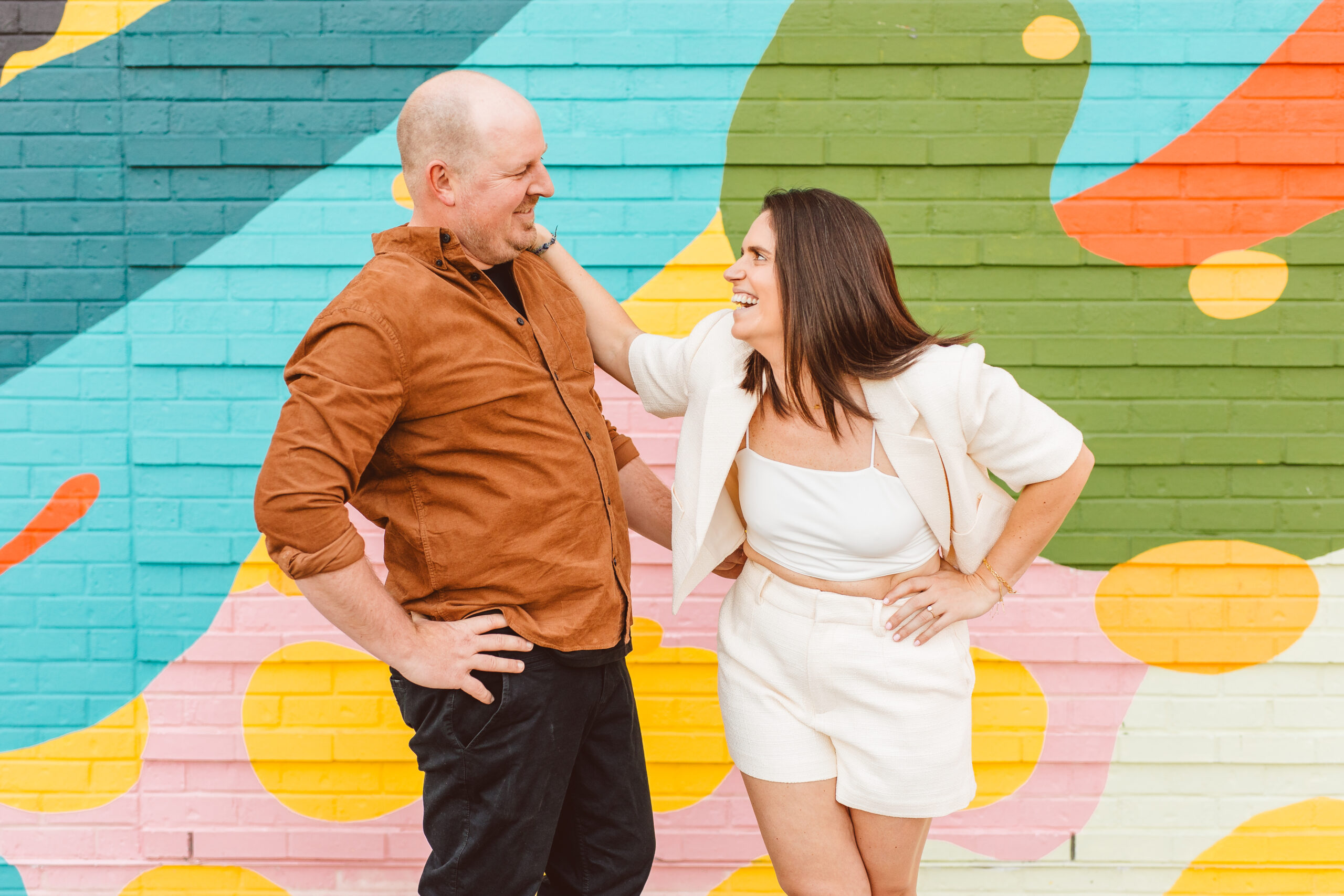 couple laughing with each other at their Romantic & Vibrant Engagement Session 