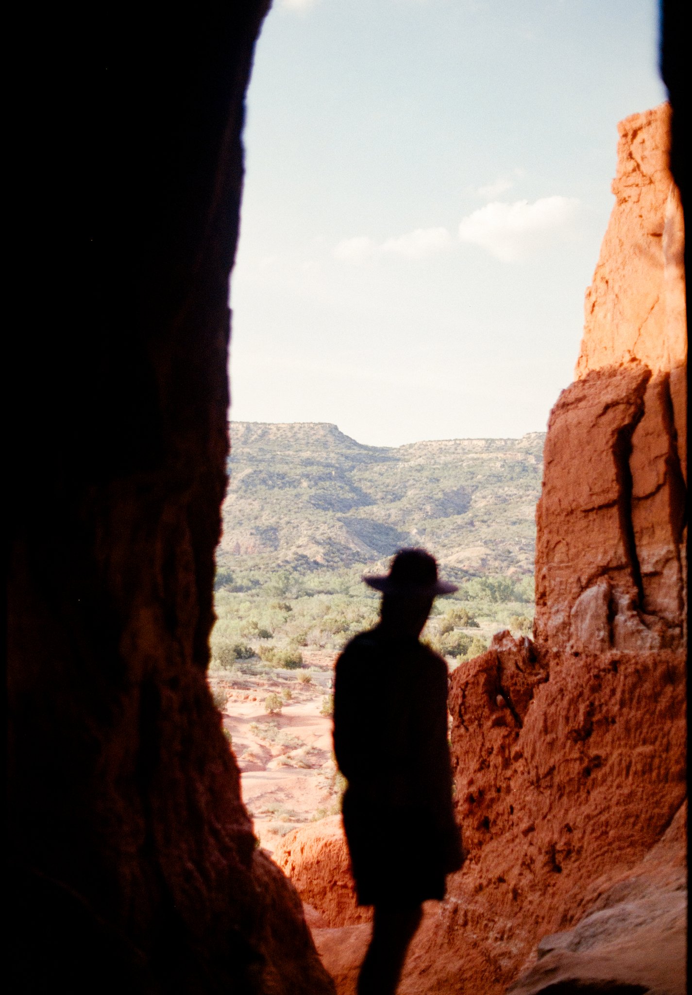 Creative shadow portrait of an eloping couple cast on red canyon rock at Palo Duro Canyon State Park, Texas