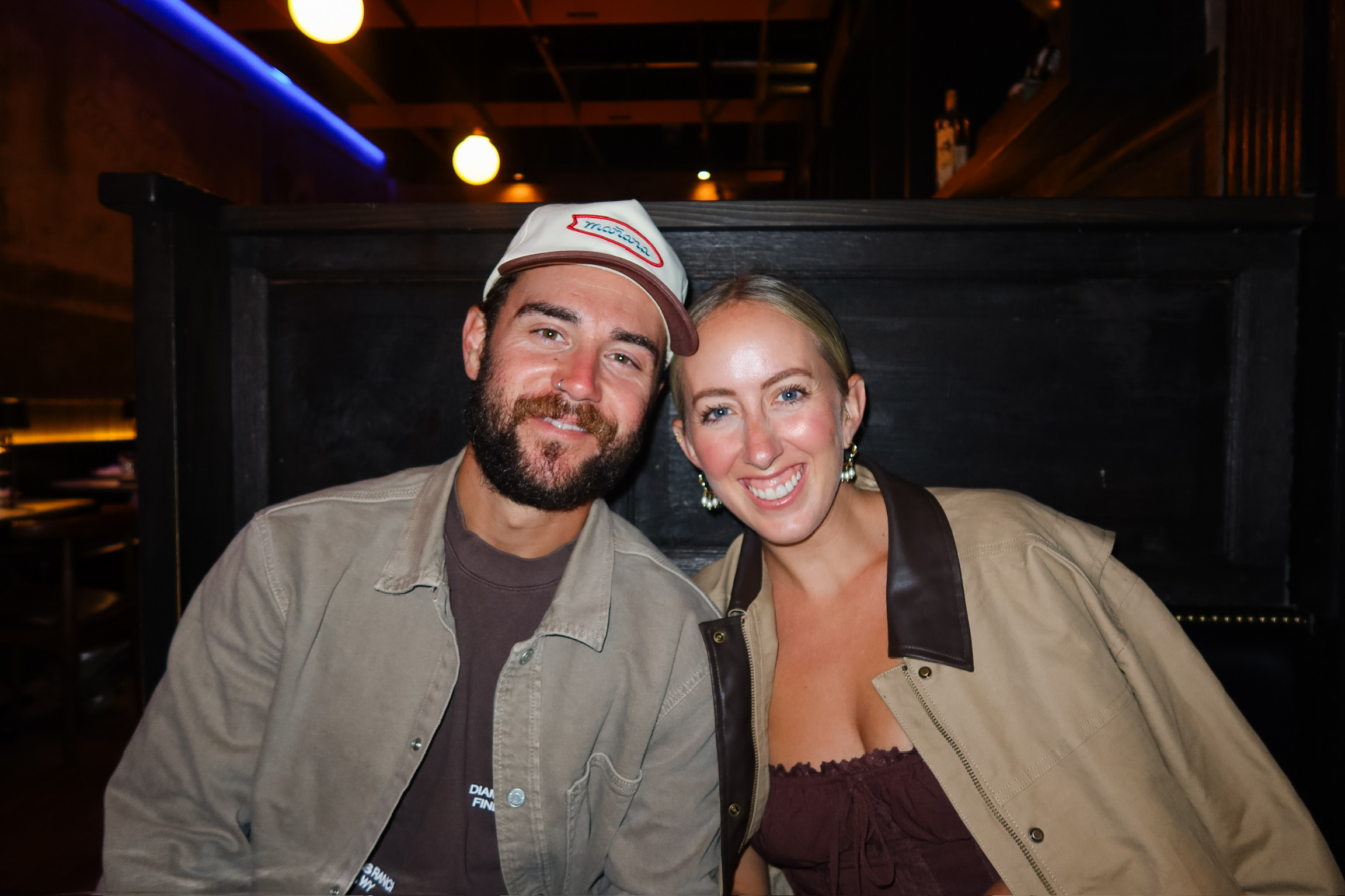 Couple smiling close together during a night out in Jackson Hole, Wyoming