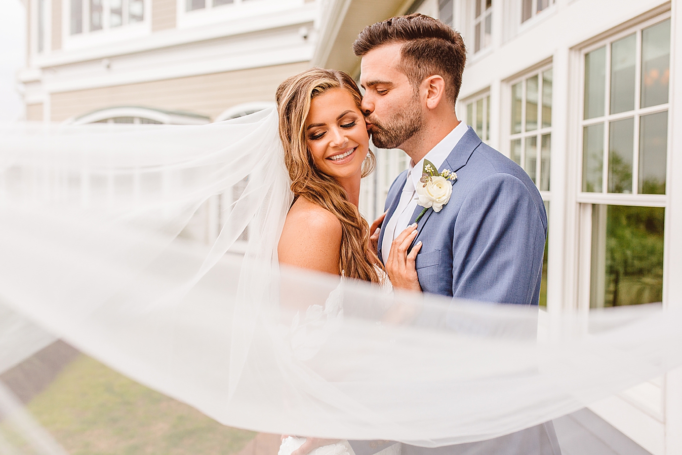 Bride and groom with veil flowing in wind | Brooke Michelle Photo