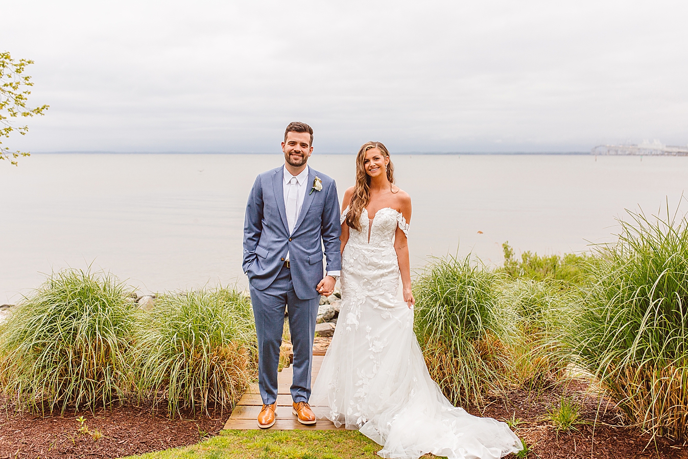 Bride and groom standing in front of bay at Chesapeake Bay Beach Club | Brooke Michelle Photo