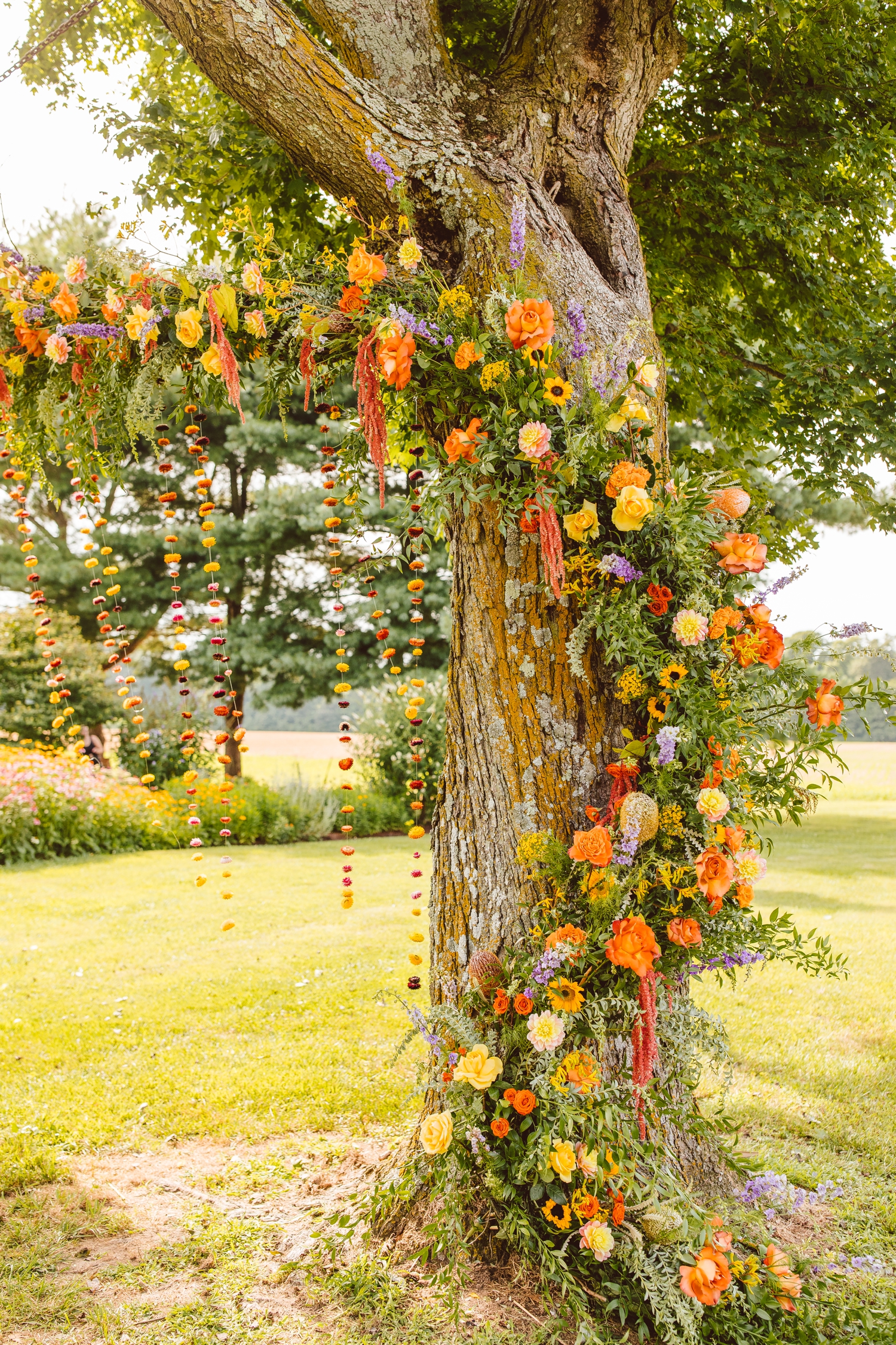 Boho floral installation on tree with hanging floral garland | Brooke Michelle Photography