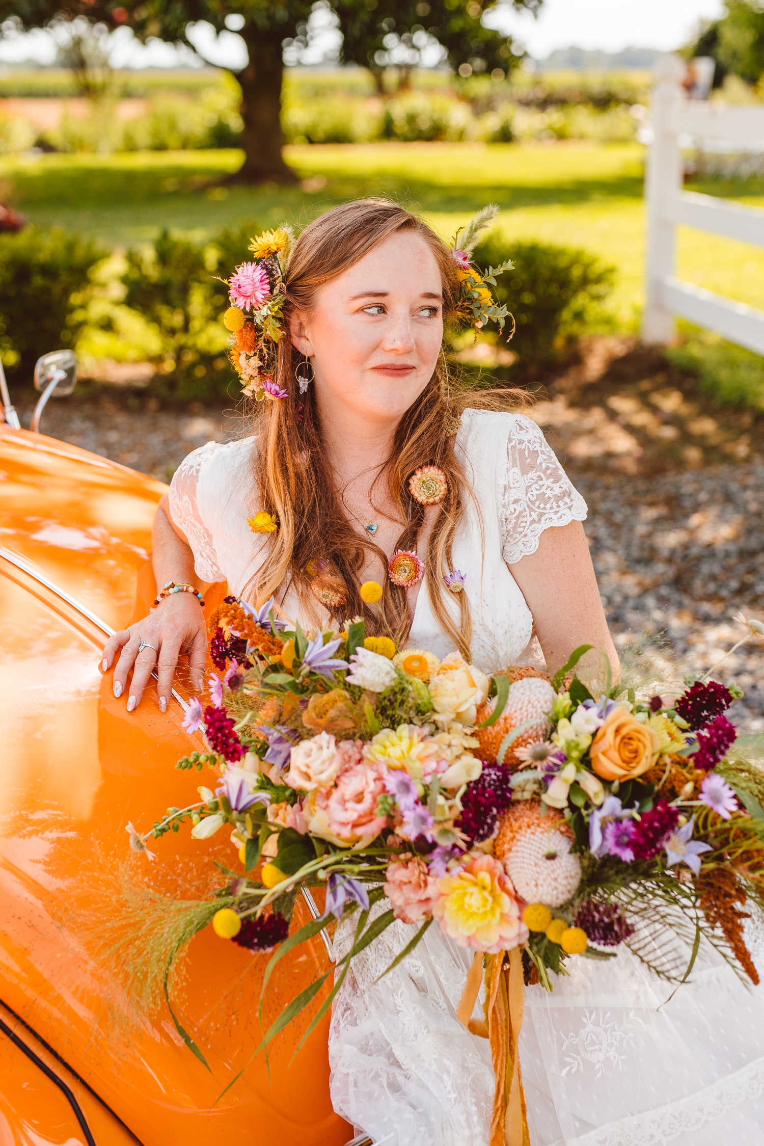 Boho bride with half floral wreath in hair holding colorful hand-tied bouquet | Brooke Michelle Photography