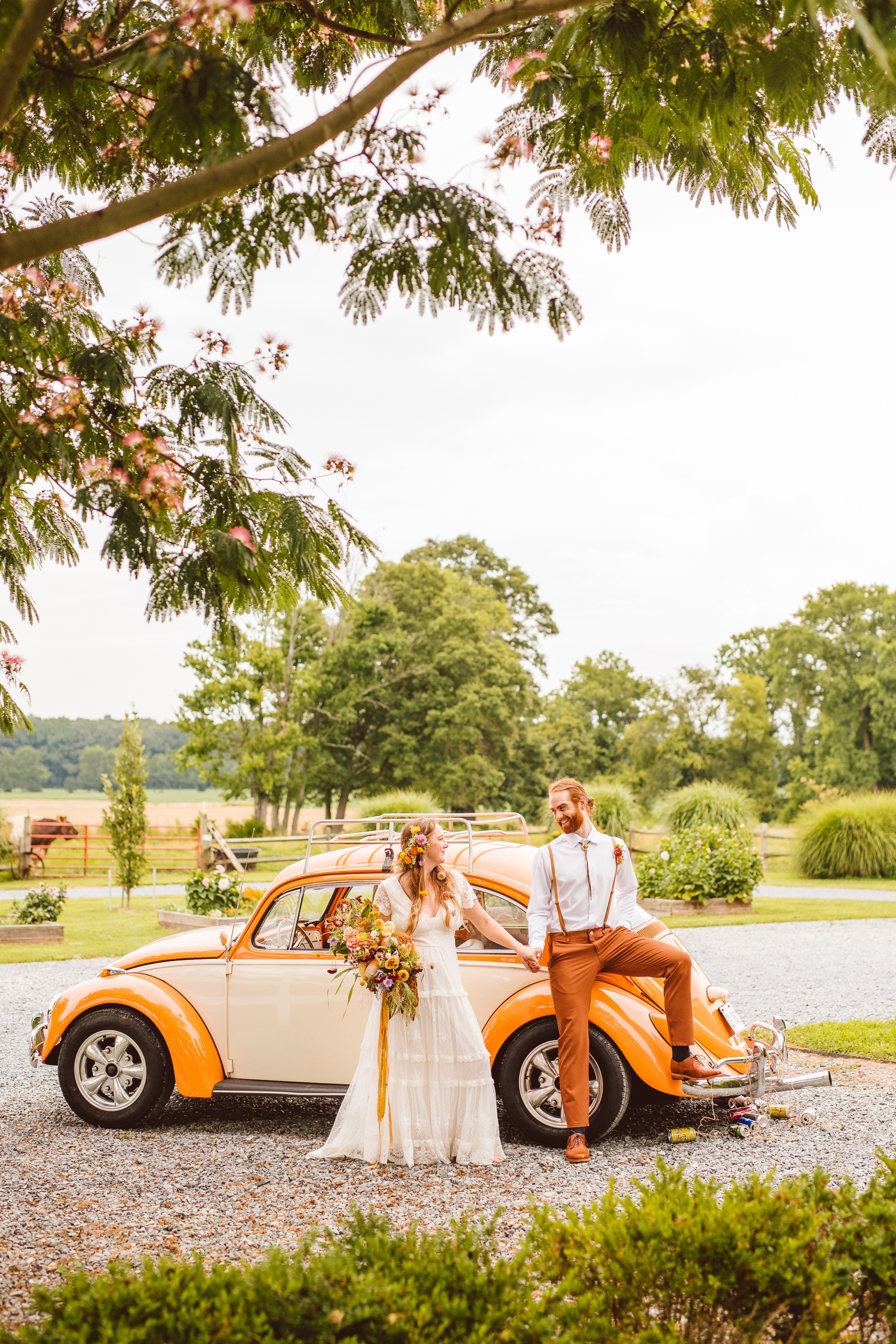 Bride and groom holding hands in front of vintage VW bug | Brooke Michelle Photography