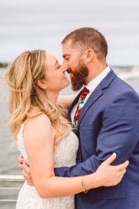 Bride and groom kissing on pier at Hamptons wedding | Brooke Michelle photography