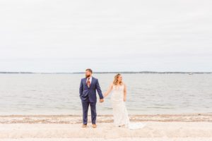 Bride and groom standing on beach in the Hamptons | Brooke Michelle Photography