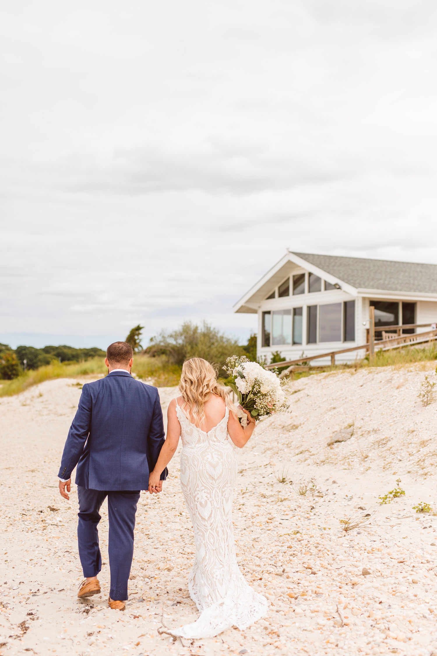 Bride and groom holding hands walking on beach | Brooke Michelle Photography
