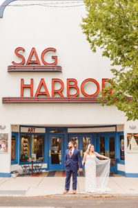 Bride and groom standing in front of Sag Harbor Cinema | Brooke Michelle Photography