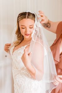 Bride in modern lace wedding dress with lace trim veil | Brooke Michelle Photography
