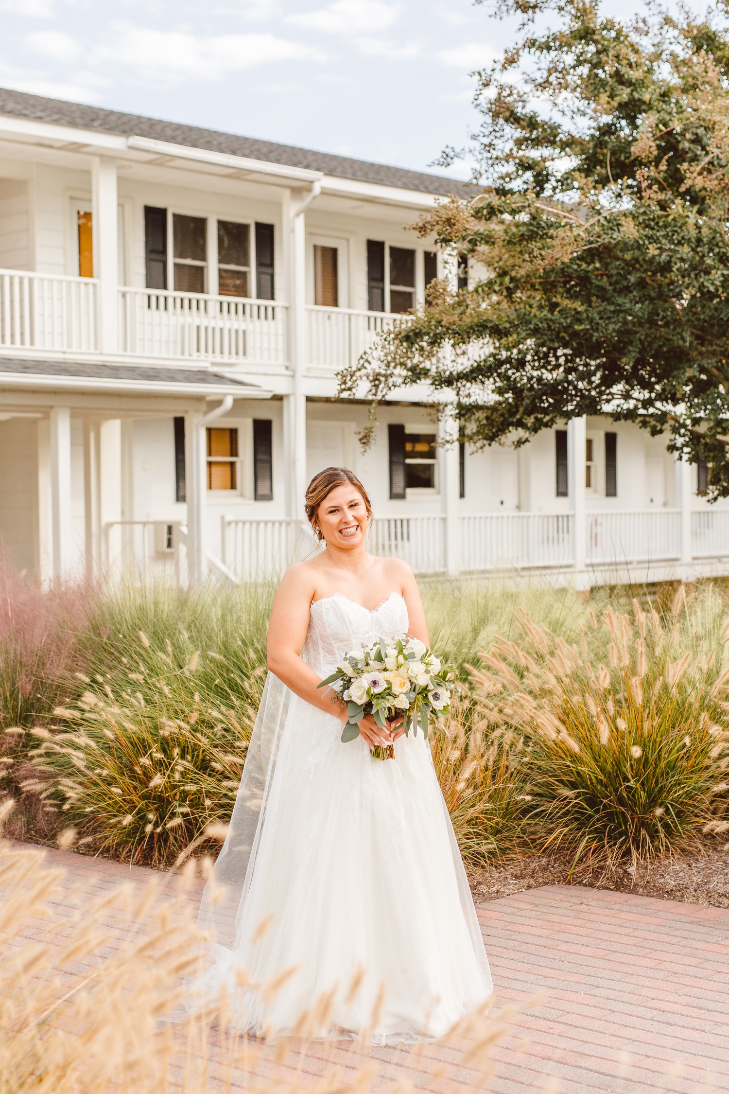 Bride holding bouquet in from of Wylder Hotel Tilghman Island | Brooke Michelle Photography