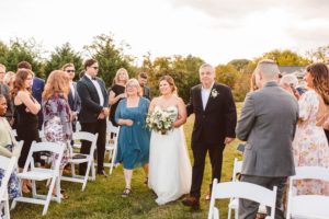 Bride walking down aisle with parents at Wylder Hotel Tilghman Island | Brooke Michelle Photography