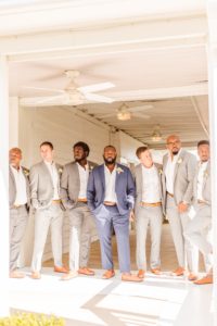 Groom and groomsmen looking off into distance at Wylder Hotel Tilghman Island | Brooke Michelle Photography