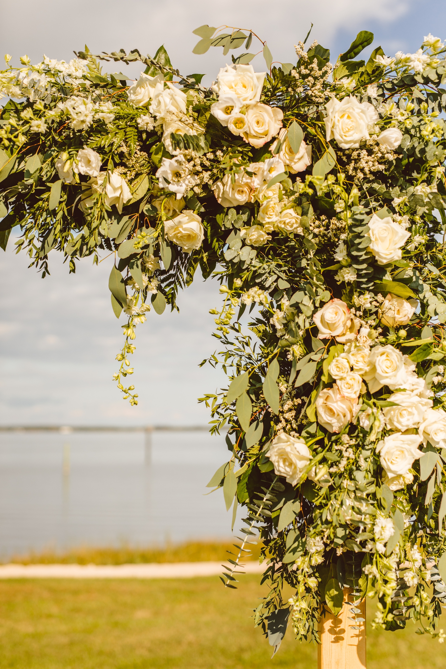 White flowers and greenery on ceremony arch at Wylder Hotel Tilghman Island | Brooke Michelle Photography