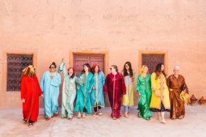 Group of women wearing traditional Moroccan outfits having picture taken by travel photographer in Marrakesh, Morocco | Brooke Michelle Photography