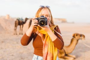 Travel photographer Brooke Michelle holding camera and taking photo in Afgay Desert | Brooke Michelle Photography