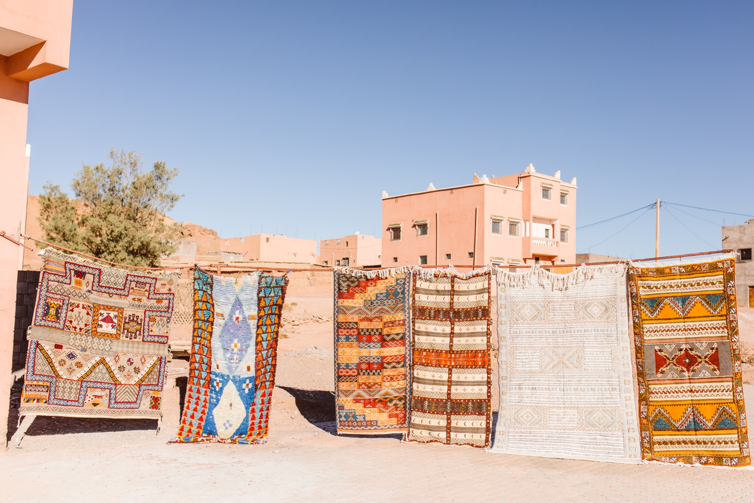 Photo taken by travel photographer of colorful rugs hanging on line outside in Marrakesh, Morocco | Brooke Michelle Photography