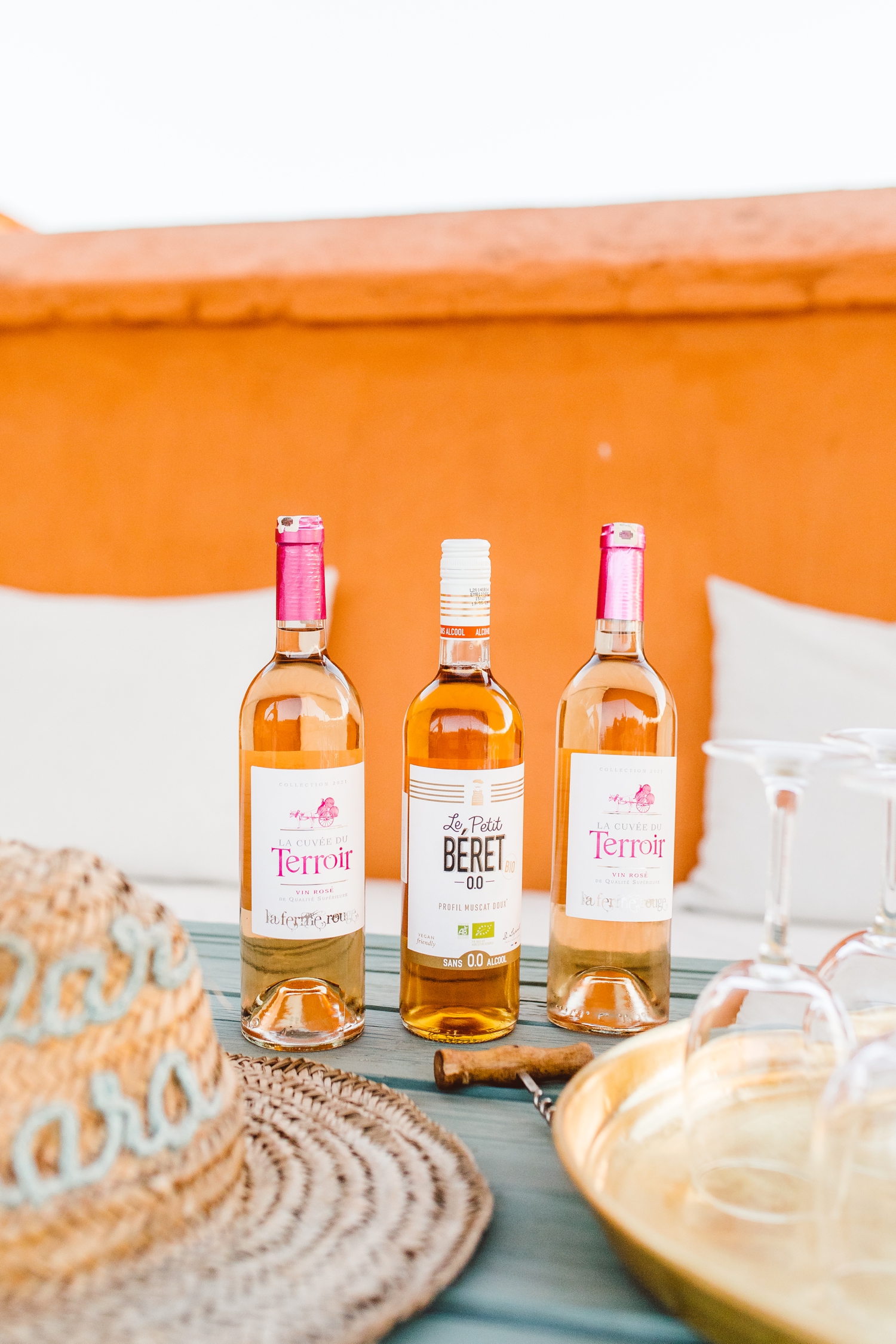 Three bottles of wine sitting on table on top of roof in Marrakesh, Morocco | Brook Michelle Photography