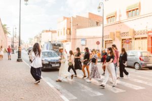 Women walking across the street in Marrakesh, Morocco as part of group trip | Brooke Michelle Photography