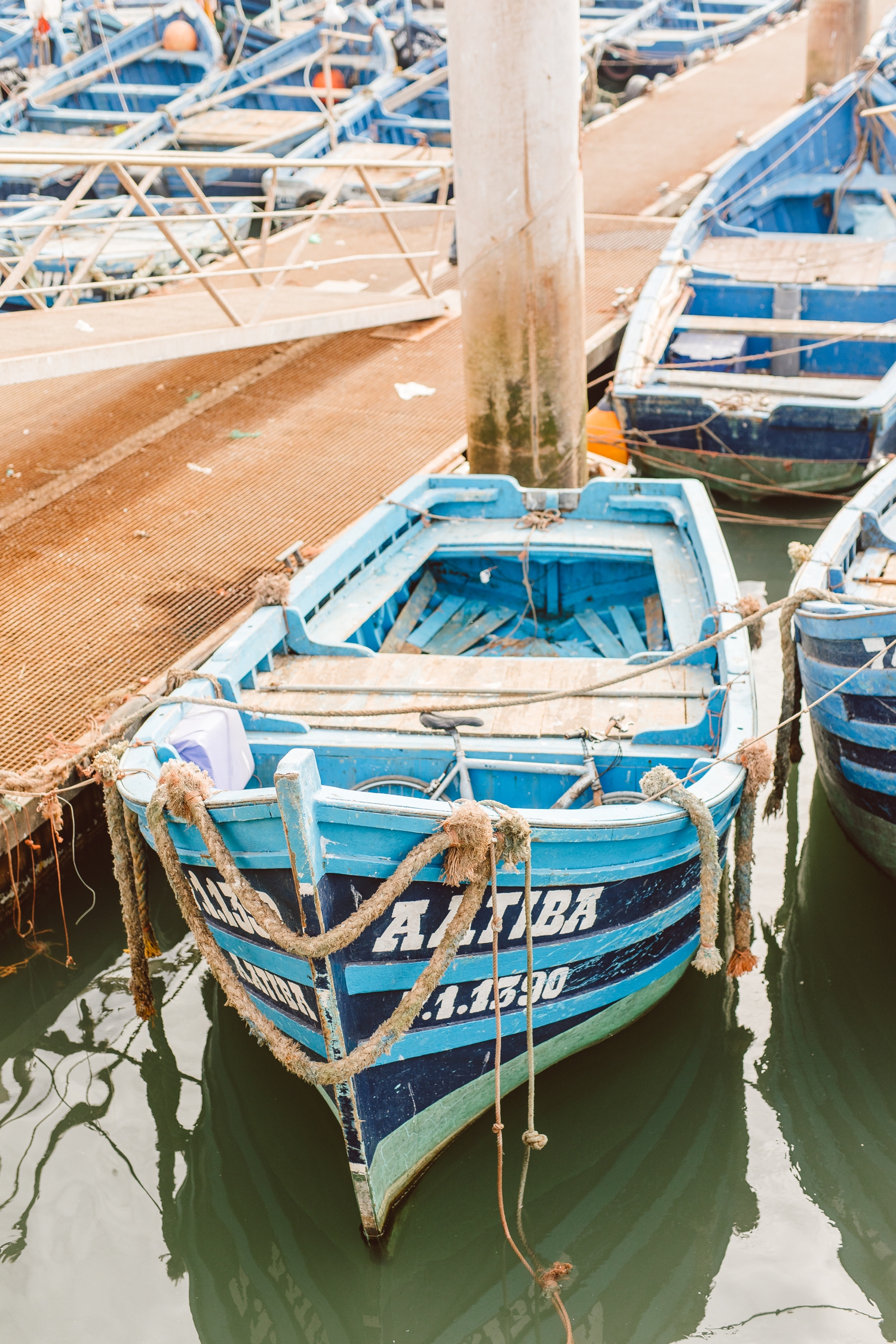 Bright blue fishing boat docked at pier in Marrakesh, Morocco | Brooke Michelle PHotography