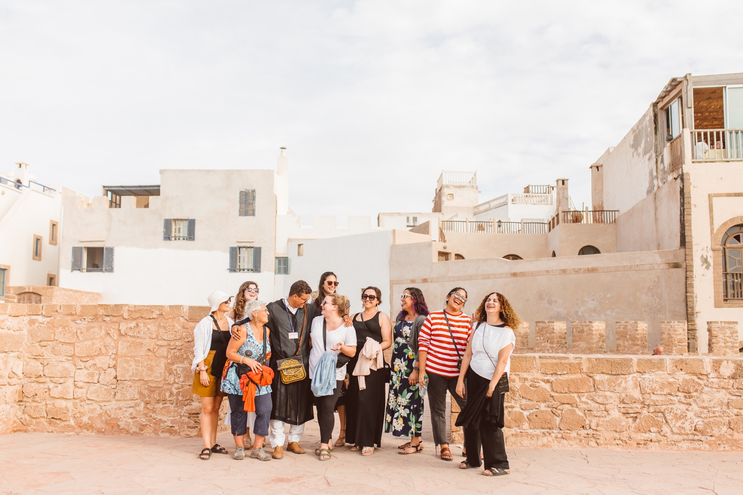 Group of women posing with travel guide on trip with travel photographer in Marrakesh, Morocco | Brooke Michelle Photography