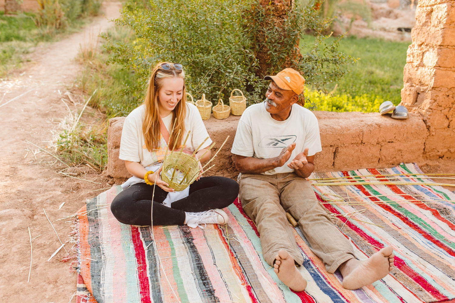 Travel photographer Brooke Michelle sitting with local merchant and learning how to weave a basket in Marrakesh, Morocco | Brooke Michelle Photography