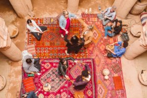 Women sitting on colorful rugs and taking part in Moroccan traditions | Brooke Michelle Photography