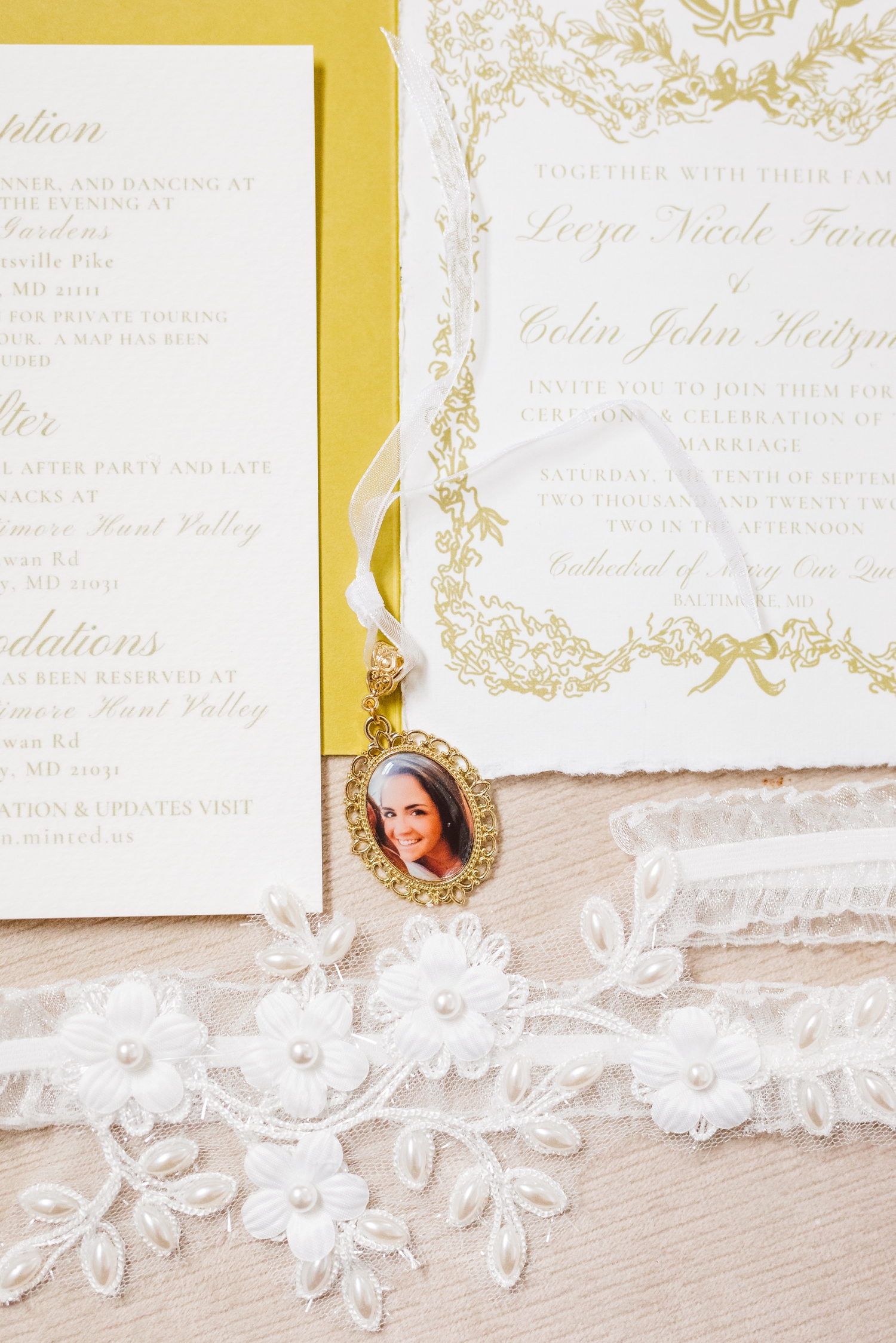 Photo of bride's sister on locket next to invitation suite | Brooke Michelle Photo