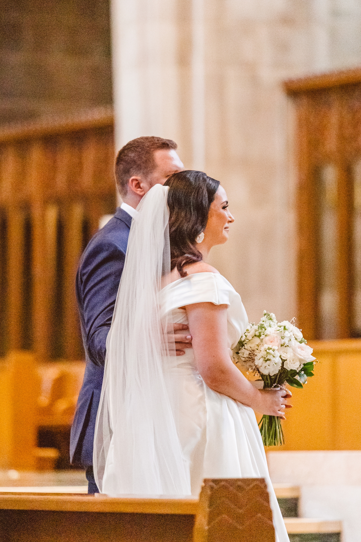 Bride and groom standing at altar at Cathedral of Mary Our Queen | Brooke Michelle Photo