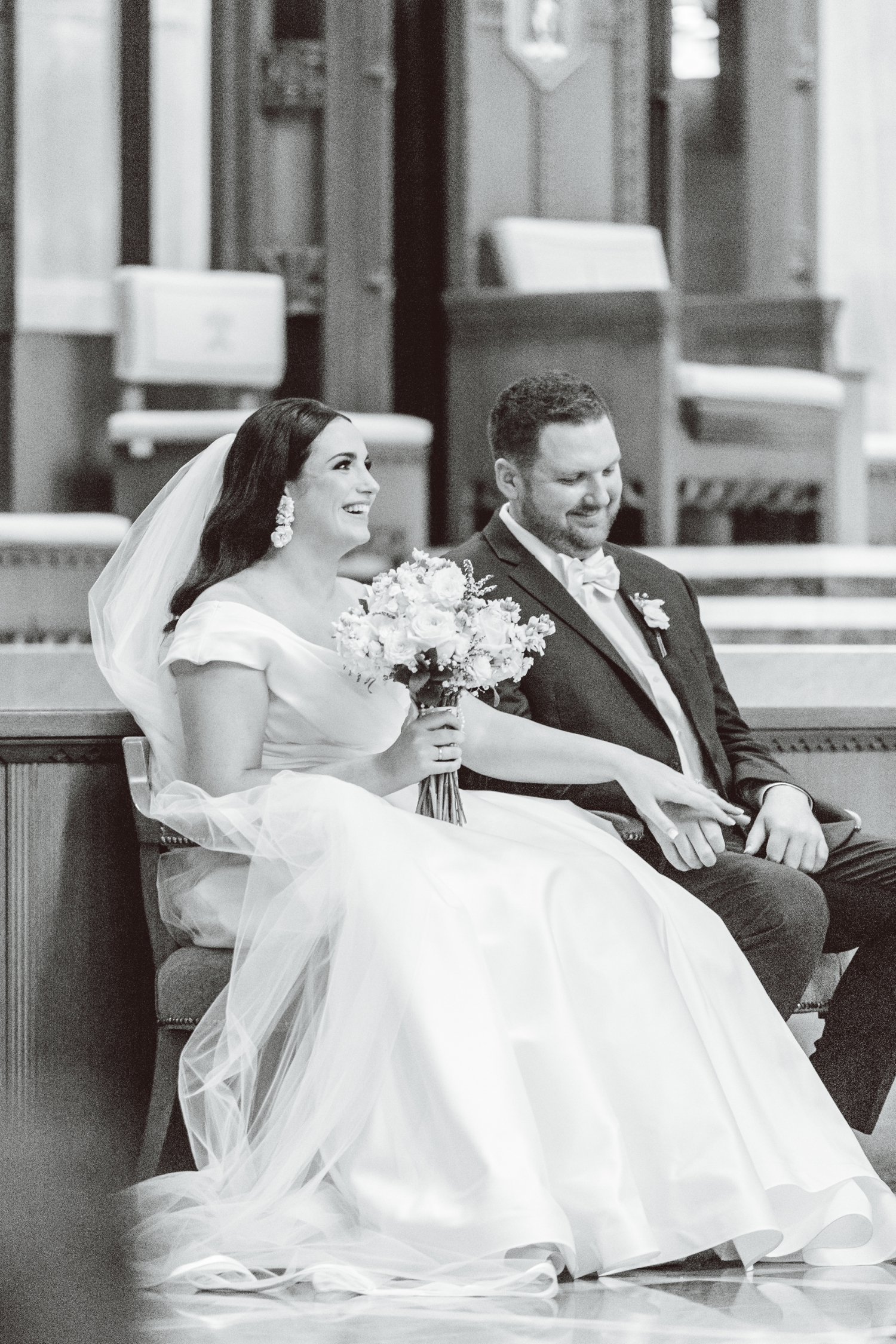Bride and groom sitting during ceremony at Cathedral of Mary Our Queen | Brooke Michelle Photo