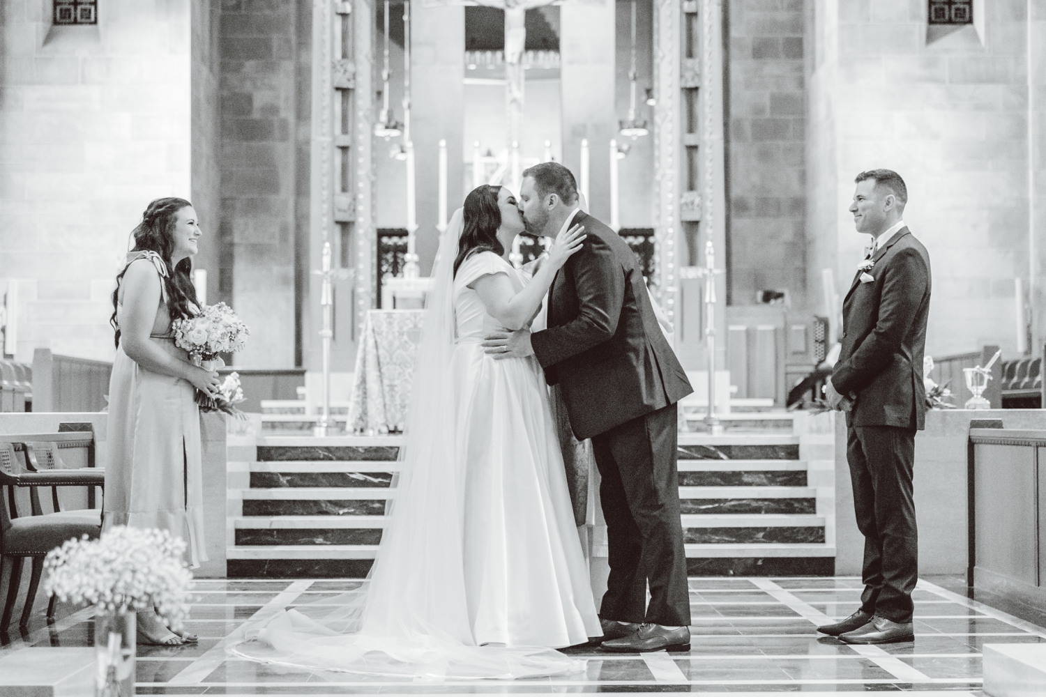 Bride and groom kissing after ceremony at Cathedral of Mary Our Queen | Brooke Michelle Photo