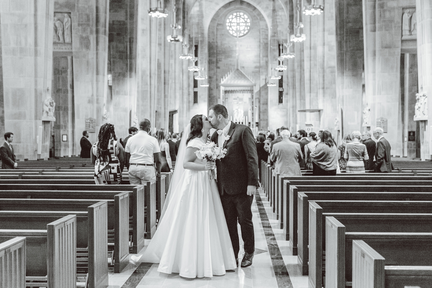 Bride and groom kissing while exiting wedding ceremony | Brooke Michelle Photo