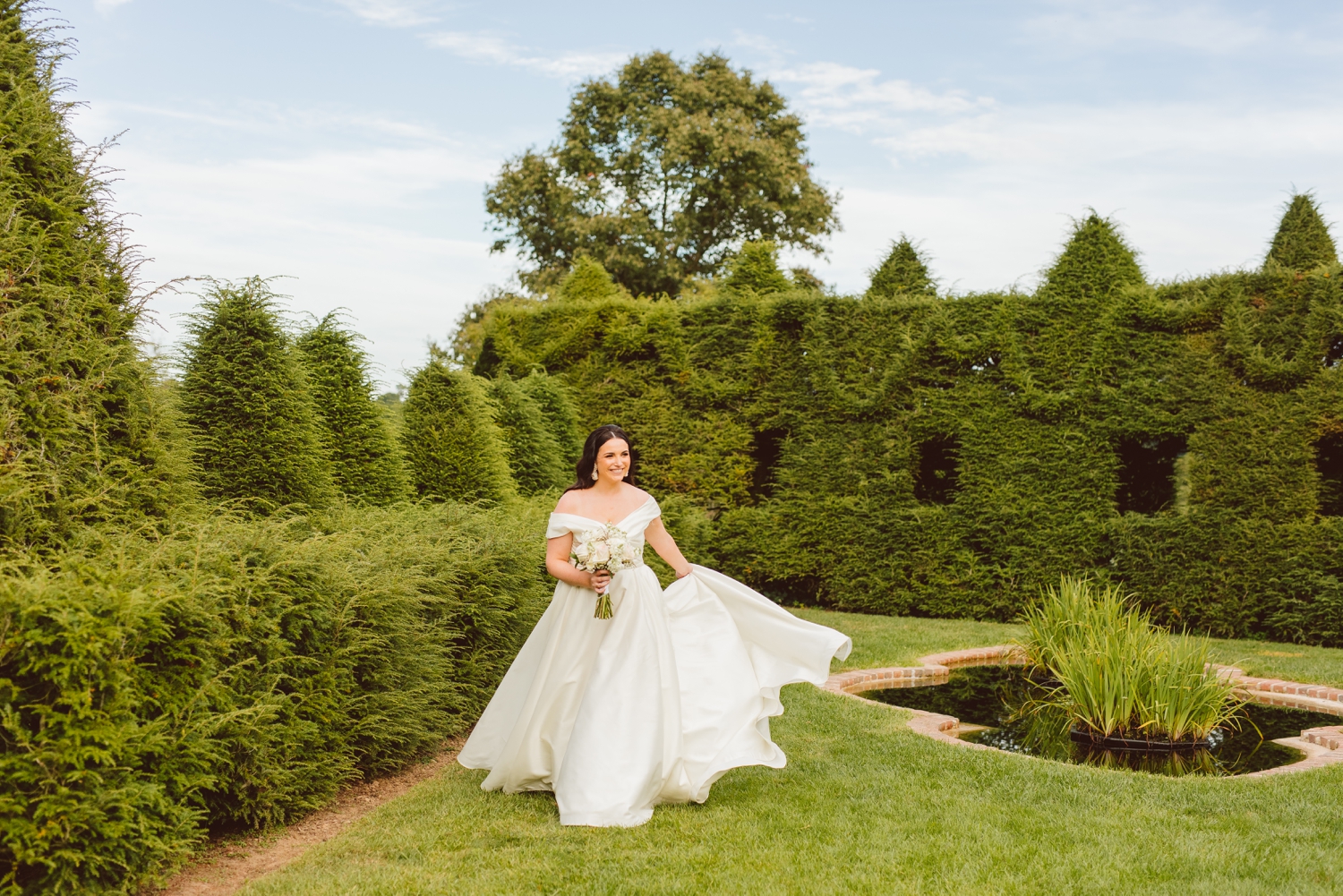 Bride walking through Ladew Topiary Gardens | Brooke Michelle Photo