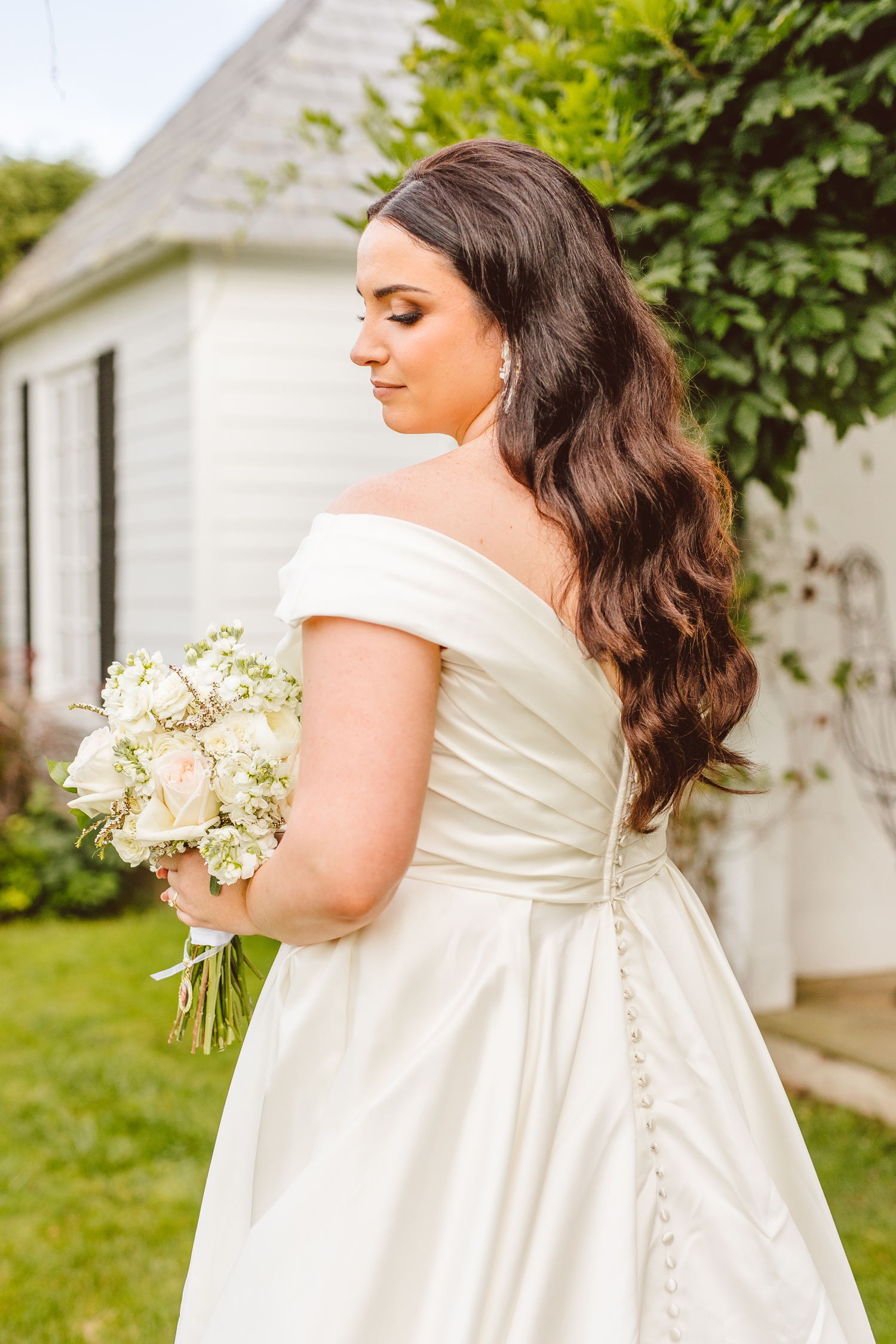 Bride wearing off the shoulder dress and looking away from camera | Brooke Michelle Photo