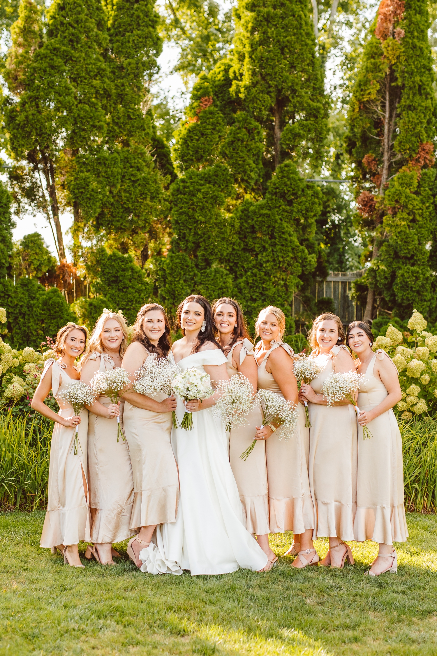 Bride with bridesmaids in champagne colored dresses at Ladew Topiary Gardens | Brooke Michelle Photo