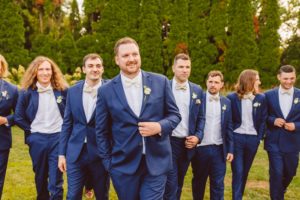 Groom and groomsmen wearing blue suits and walking towards camera | Brooke Michelle Photo