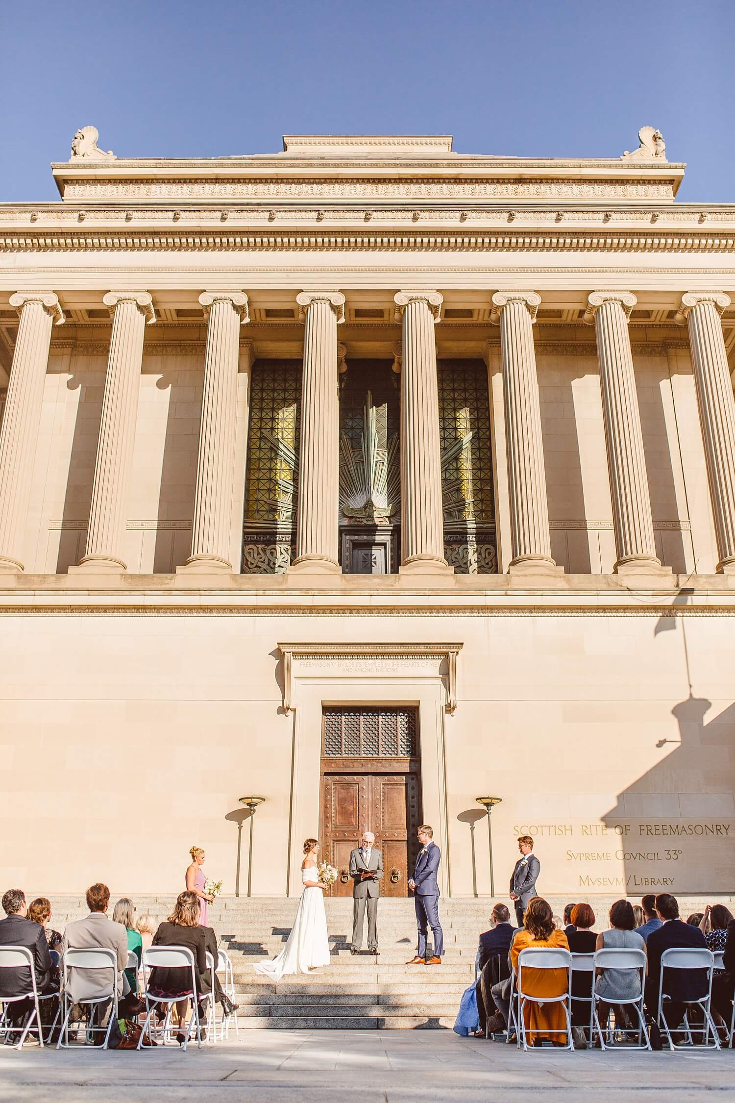 Couple standing on the steps of the Scottish Rite House of the Temple during wedding ceremony | Brooke Michelle Photography