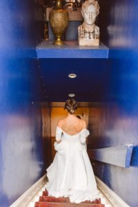 Bride walking down blue staircase to basement at lapis | Brooke Michelle Photography