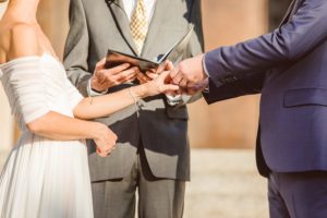 Groom placing ring on bride's hand during wedding ceremony | Brooke Michelle Photography