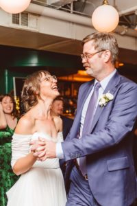 Bride and groom laughing while dancing during reception | Brooke Michelle Photography