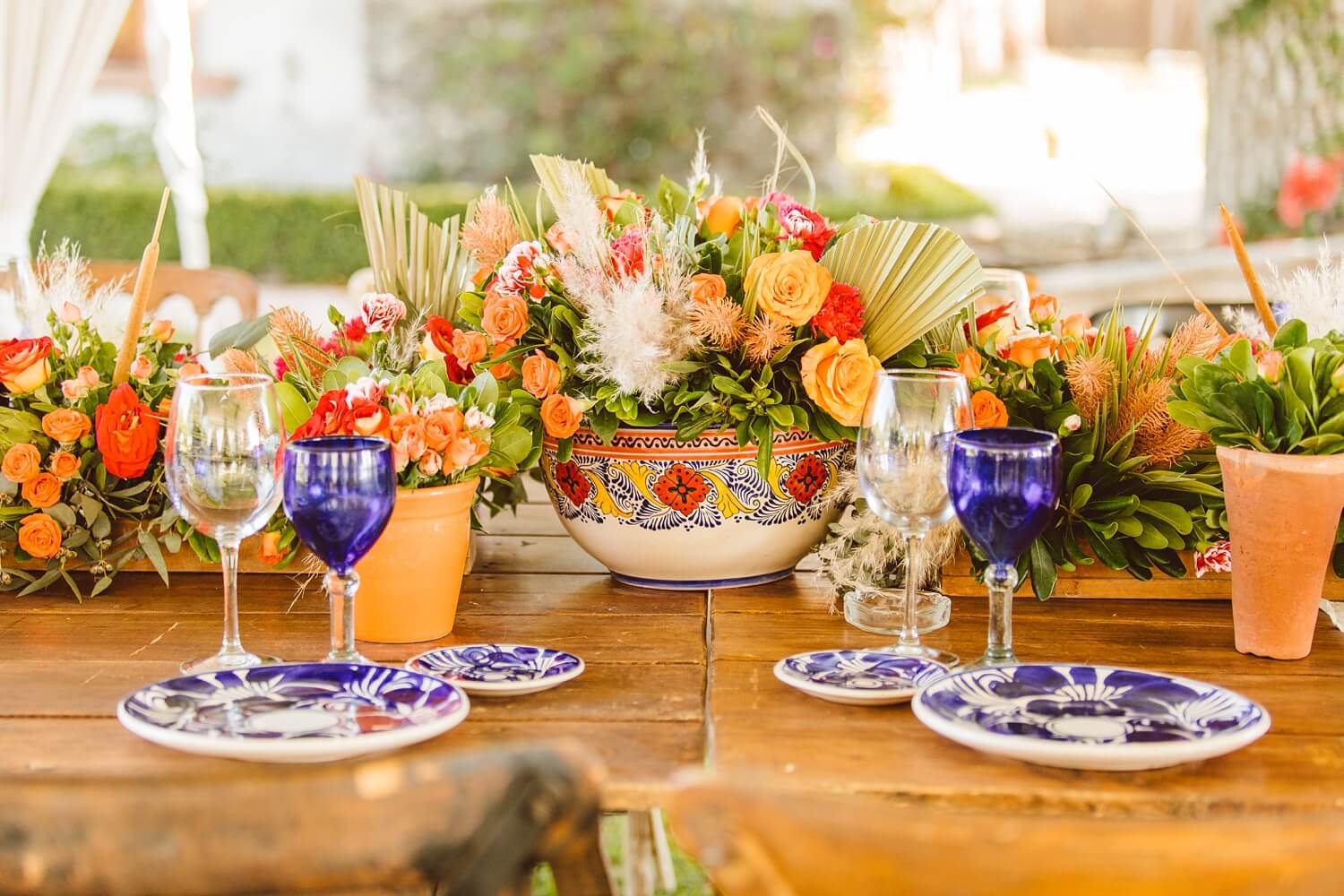 Colorful flowers in painted bowl with blue cups and talavera plates | Brooke Michelle Photo