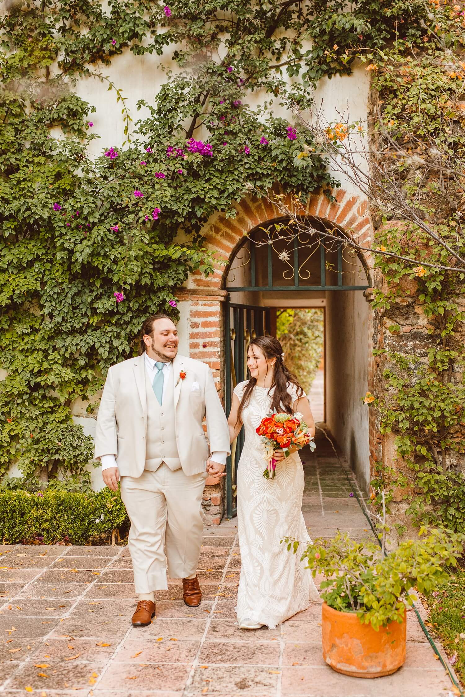 Bride and groom walking and holding hands at Hacienda Amazcala | Brooke Michelle Photo