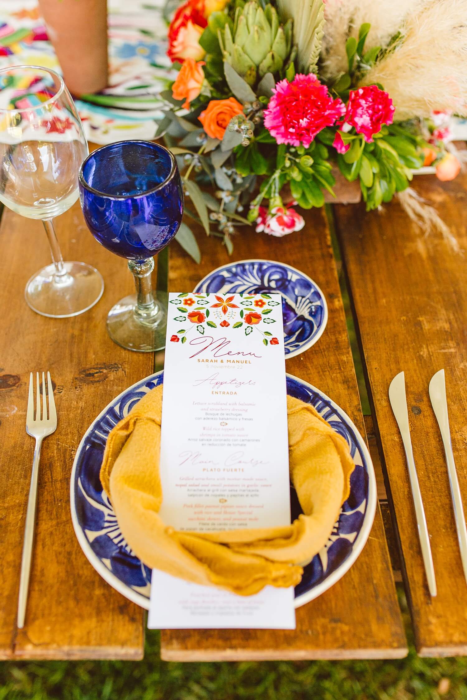 Blue and white talavera plates with yellow napkin and colorful menu at wedding reception | Brooke Michelle Photo