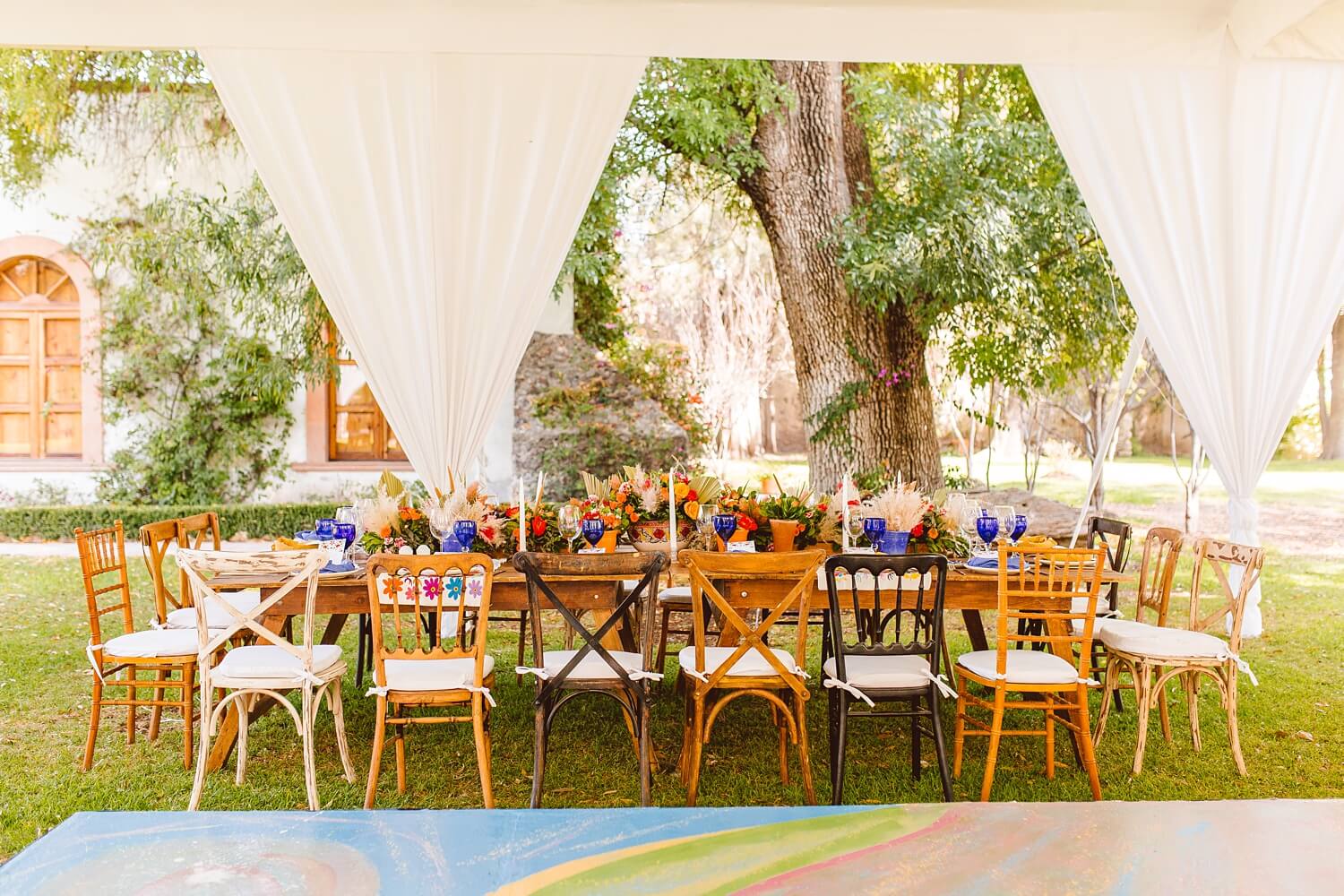 Mismatched chairs with vibrant flowers at reception | Brooke Michelle Photo