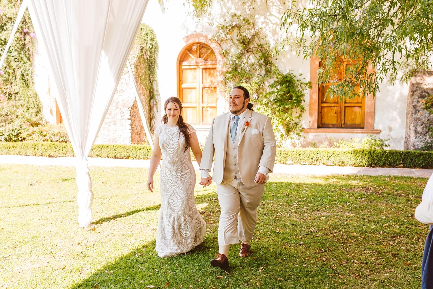 Bride and groom walking into reception at Mexico destination wedding | Brooke Michelle Photo