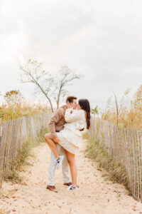 Couple posing for romantic engagement engagement photoshoot beach session