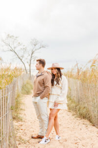 Couple posing for romantic engagement engagement photoshoot beach session