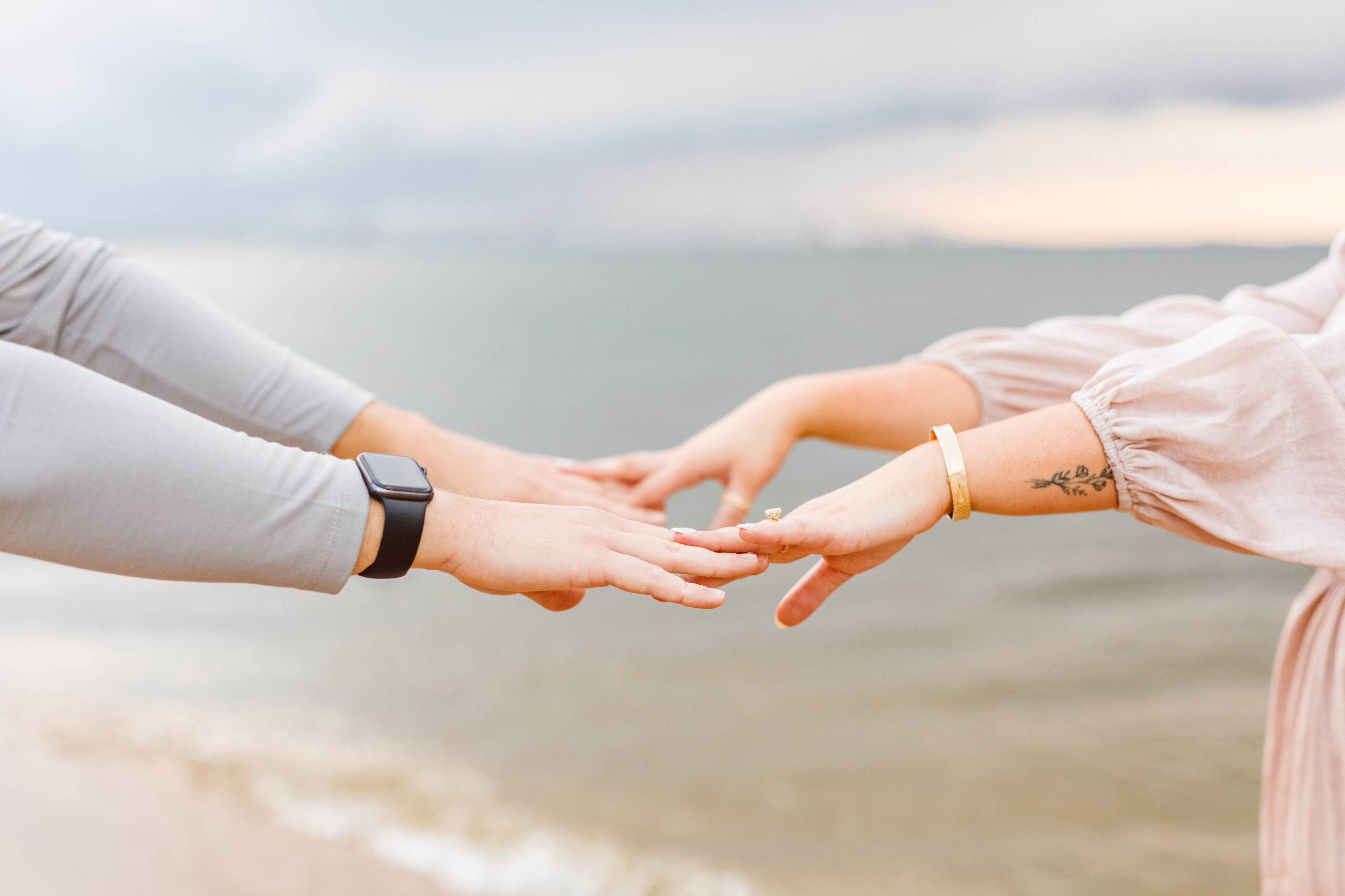Couple holding hands on the beach