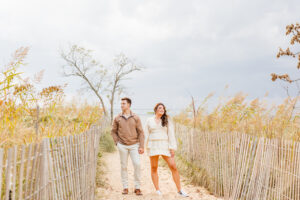 Couple posing for boho engagement beach photoshoot photos
