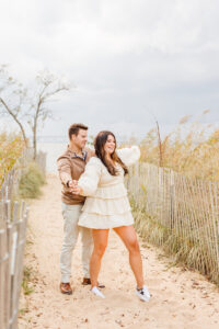 Couple posing for boho engagement photoshoot beach session photos