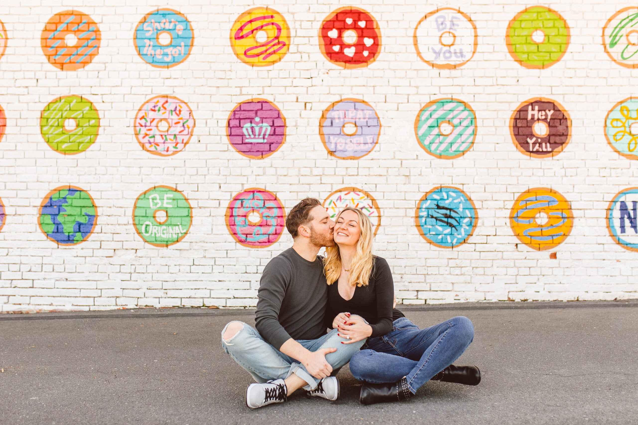 Dre Charlotte Influencer posing in front of Donut Wall 6. Donut Wall by Gina Elizabeth Franco at 2116 Hawkins St